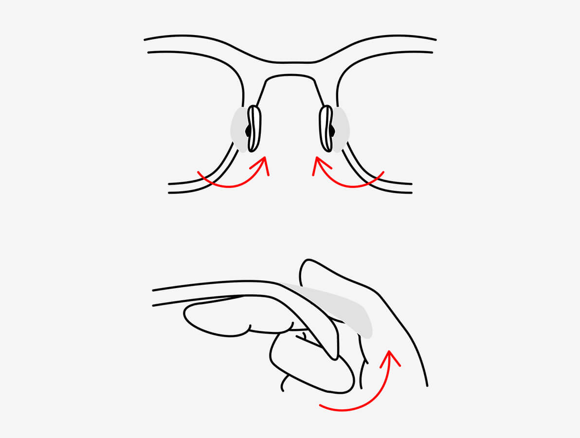 Piirretty kuva silmälaseista, joissa nenätyynyt on merkitty, ja kädessä, joka taivuttaa kehystä.