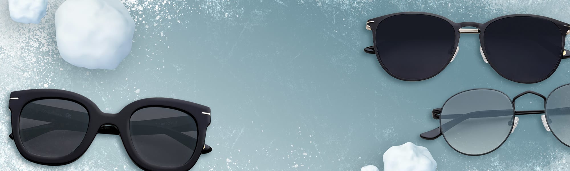 Kolme paria mustia aurinkolaseja on jäällä, lumipallojen ympäröiminä.